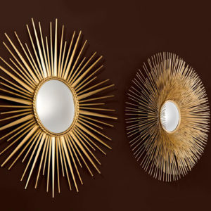 The Helios Mirror by Eichholtz against a black backdrop.