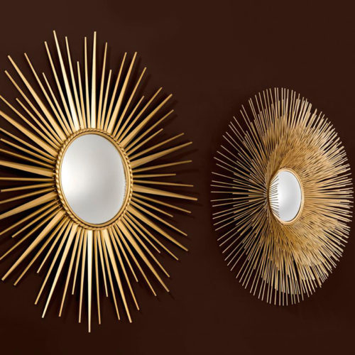 The Helios Mirror by Eichholtz against a black backdrop.